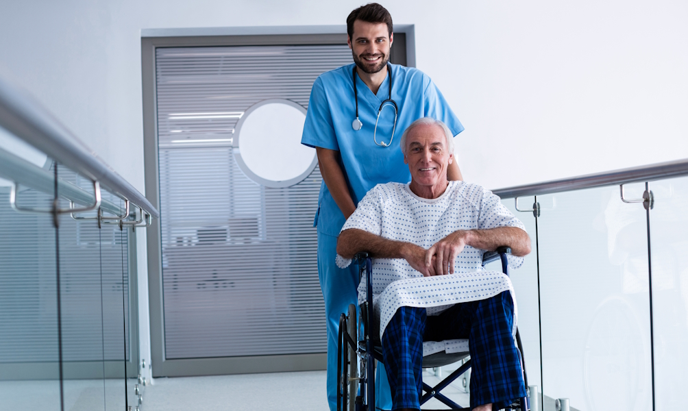 Doctor pushing a patient on wheelchair