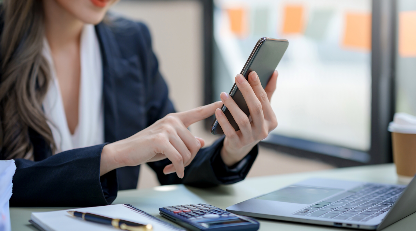 Woman using smartphone working with various applications